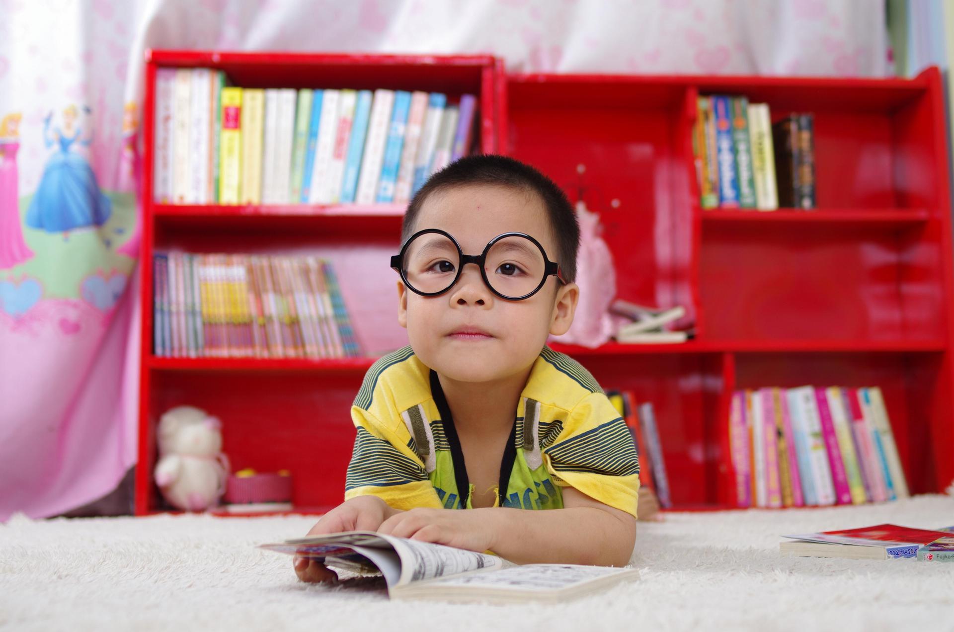 A young student learning to read and write in a homeschool co-op